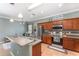 Well-equipped kitchen with stainless steel appliances, wooden cabinets, a sink with a view, and modern lighting fixtures at 2721 Stonewood Dr, Lakeland, FL 33810