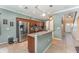Well-equipped kitchen with stainless steel appliances, wooden cabinets, and a kitchen island with bar-stool seating at 2721 Stonewood Dr, Lakeland, FL 33810