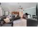 Open-concept living room flowing into the kitchen, with a ceiling fan and comfortable leather seating arrangements at 2721 Stonewood Dr, Lakeland, FL 33810