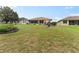 Large grassy backyard with mature landscaping at 6442 Bendelow Dr, Lakeland, FL 33810
