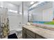 Cozy bathroom featuring a floral shower curtain, granite counter tops and a decorative mirror at 6442 Bendelow Dr, Lakeland, FL 33810