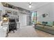 Well-lit bedroom featuring desk, shelving, closet and love seat for studying or relaxing at 6442 Bendelow Dr, Lakeland, FL 33810