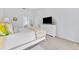Bright bedroom featuring a decorative TV on a white dresser and light, plush carpeting at 6442 Bendelow Dr, Lakeland, FL 33810