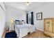 Bright bedroom featuring a bed with blue accents, hardwood floors and natural lighting at 6442 Bendelow Dr, Lakeland, FL 33810