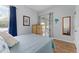Bedroom with sliding glass doors, a decorative mirror and a dresser with palm tree accents at 6442 Bendelow Dr, Lakeland, FL 33810