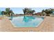 A spacious community pool with clear blue water, surrounded by lounge chairs and umbrellas, offering a relaxing recreational space at 6442 Bendelow Dr, Lakeland, FL 33810