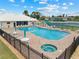 A community pool area with lounge chairs, tables, and a hot tub, offering an ideal space for relaxation and social activities at 6442 Bendelow Dr, Lakeland, FL 33810