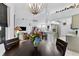 Open concept space with a dining table, view of the kitchen, and bright, airy atmosphere at 6442 Bendelow Dr, Lakeland, FL 33810