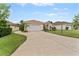 Charming single-story home featuring a well-manicured lawn and long driveway at 6442 Bendelow Dr, Lakeland, FL 33810