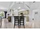 Bright kitchen with bar seating, modern appliances, and a view of the living room at 6442 Bendelow Dr, Lakeland, FL 33810