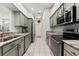Galley kitchen with marble countertops, stainless steel appliances, and white tile floors at 6442 Bendelow Dr, Lakeland, FL 33810