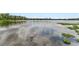 Scenic lake view reflecting the sky and surrounded by lush greenery, offering a peaceful and natural setting at 6442 Bendelow Dr, Lakeland, FL 33810