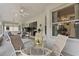 Enclosed lanai with ceiling fans, round glass table and sliding glass doors to inside at 6442 Bendelow Dr, Lakeland, FL 33810