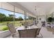 Enclosed lanai with neutral color palette, ceiling fans, and views of the manicured backyard at 6442 Bendelow Dr, Lakeland, FL 33810