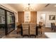 Dining room features modern chandelier, stylish seating for six, and sliding glass doors at 1820 N Merrick Dr, Deltona, FL 32738