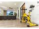 Bright exercise area featuring an exercise bike near large windows and a TV in the background at 1820 N Merrick Dr, Deltona, FL 32738