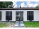 Charming house with well-manicured front yard and inviting front door entrance at 1820 N Merrick Dr, Deltona, FL 32738
