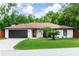 Beautiful home with manicured lawn, brick exterior, dark trim, and mature trees at 1820 N Merrick Dr, Deltona, FL 32738