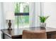 Bright home office featuring a dark wood desk with stylish lamp, plant and natural light at 1820 N Merrick Dr, Deltona, FL 32738