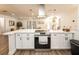Bright, open kitchen featuring stainless steel appliances, modern lighting, and quartz countertops at 1820 N Merrick Dr, Deltona, FL 32738