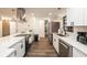 Sleek kitchen with stainless steel appliances, white cabinetry and expansive quartz countertops at 1820 N Merrick Dr, Deltona, FL 32738