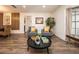 Comfortable living room showcasing hardwood floors, with an open flow to kitchen and dining areas at 1820 N Merrick Dr, Deltona, FL 32738