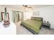 Spacious main bedroom with a ceiling fan, plush carpet, and ensuite bath at 1820 N Merrick Dr, Deltona, FL 32738