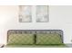 Cozy bedroom with a comfortable bed, decorative pillows, and elegant artwork at 1820 N Merrick Dr, Deltona, FL 32738