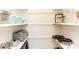 Organized pantry featuring shelving with cookware, toaster oven, glassware, and food containers at 1820 N Merrick Dr, Deltona, FL 32738