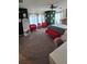 Spacious bedroom with unique playing card decor, red chairs, and a large mirror at 153 Tigerlily Ct, Davenport, FL 33837
