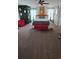Bright bedroom with unique playing card decor, red chairs, and a large comfy bed at 153 Tigerlily Ct, Davenport, FL 33837