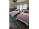Charming bedroom with two beds, seashell pillows, and a beachy, nautical decor at 153 Tigerlily Ct, Davenport, FL 33837