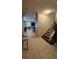 Bright entryway with ceramic tile flooring, staircase and whimsical Mickey Mouse wall decor at 153 Tigerlily Ct, Davenport, FL 33837