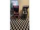 Fun game room with vintage Ms. Pac-Personal and Star Wars arcade games on checkered rug at 153 Tigerlily Ct, Davenport, FL 33837
