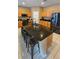 Spacious kitchen island features a dark countertop with bar seating and is surrounded by ample cabinetry at 153 Tigerlily Ct, Davenport, FL 33837