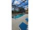 Sparkling in-ground pool and hot tub offers a refreshing outdoor oasis within a screened enclosure at 153 Tigerlily Ct, Davenport, FL 33837