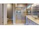 Modern bathroom with a glass-enclosed shower, vanity with sink, and contemporary fixtures at 5653 Nevis Ter, Kissimmee, FL 34758