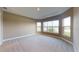Expansive bedroom with plush carpeting, tray ceiling, and multiple windows offering water views at 5653 Nevis Ter, Kissimmee, FL 34758