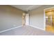 Comfortable bedroom featuring neutral carpeting, ample natural light, and access to an en-suite bathroom at 5653 Nevis Ter, Kissimmee, FL 34758