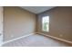Comfortable bedroom with neutral walls, carpet, and window with a pleasant outdoor view at 5653 Nevis Ter, Kissimmee, FL 34758