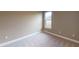 Bright bedroom with soft carpeting, neutral walls, and a window for natural lighting at 5653 Nevis Ter, Kissimmee, FL 34758