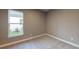 Cozy bedroom with plush carpeting, neutral walls, and a bright window for natural light at 5653 Nevis Ter, Kissimmee, FL 34758