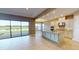 Open-concept kitchen featuring a large island, stainless steel appliances, and a spacious dining area at 5653 Nevis Ter, Kissimmee, FL 34758