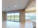 Open living room showcasing large sliding glass doors with stunning views of the lake and backyard at 5653 Nevis Ter, Kissimmee, FL 34758