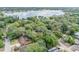 Aerial view showcasing the neighborhood's lush trees and the expansive lake at 110 E Lauren Ct, Fern Park, FL 32730