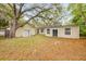 Residential backyard showcasing two buildings, lush greenery, and mature trees at 110 E Lauren Ct, Fern Park, FL 32730
