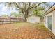 Backyard showcasing lush greenery and a classic wooden fence for privacy at 110 E Lauren Ct, Fern Park, FL 32730