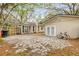 Backyard featuring a concrete and stone patio, fence, and mature trees at 110 E Lauren Ct, Fern Park, FL 32730