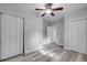Bedroom with neutral walls, wood-style floors, ceiling fan, and ample closet space for storage at 110 E Lauren Ct, Fern Park, FL 32730