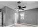 Bedroom with a ceiling fan, natural light from the window, and wood-style floors at 110 E Lauren Ct, Fern Park, FL 32730
